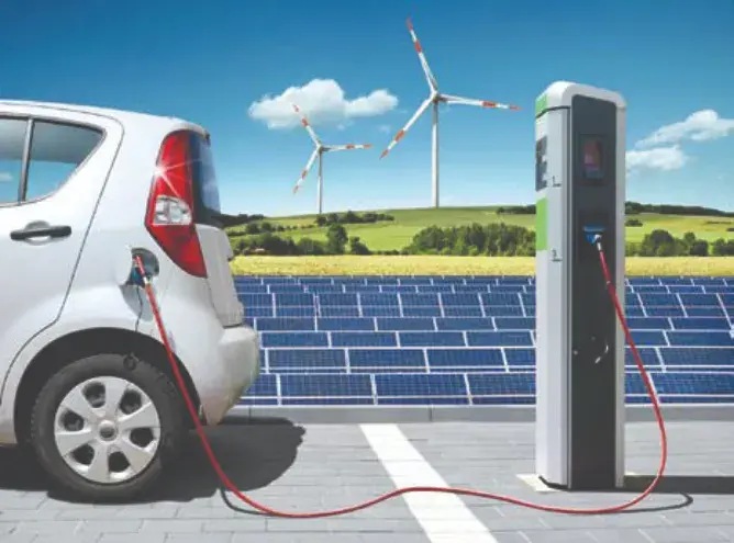 Electric car on charging spot with solar panels and wind energy in front of landscape (Showing application of power devices using SiC Trench MOSFETs