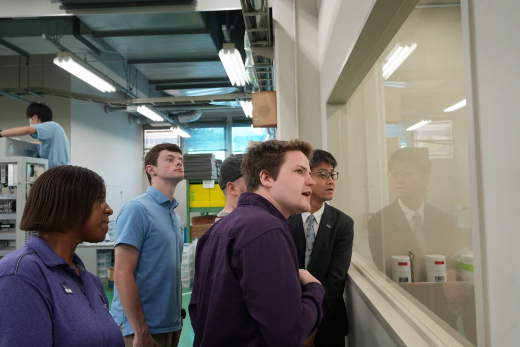 University of Central Arkansas (UCA) staff and students being shown the cleanroom at the production facility during their tour.